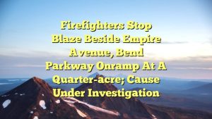 Firefighters stop blaze beside Empire Avenue, Bend Parkway onramp at a quarter-acre; cause under investigation